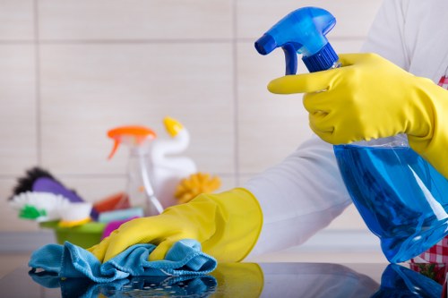Cleaner working in a typical Ilford home living room