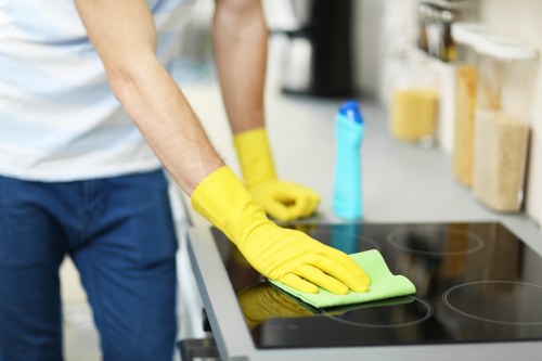Local oven cleaning technician working on a range cooker